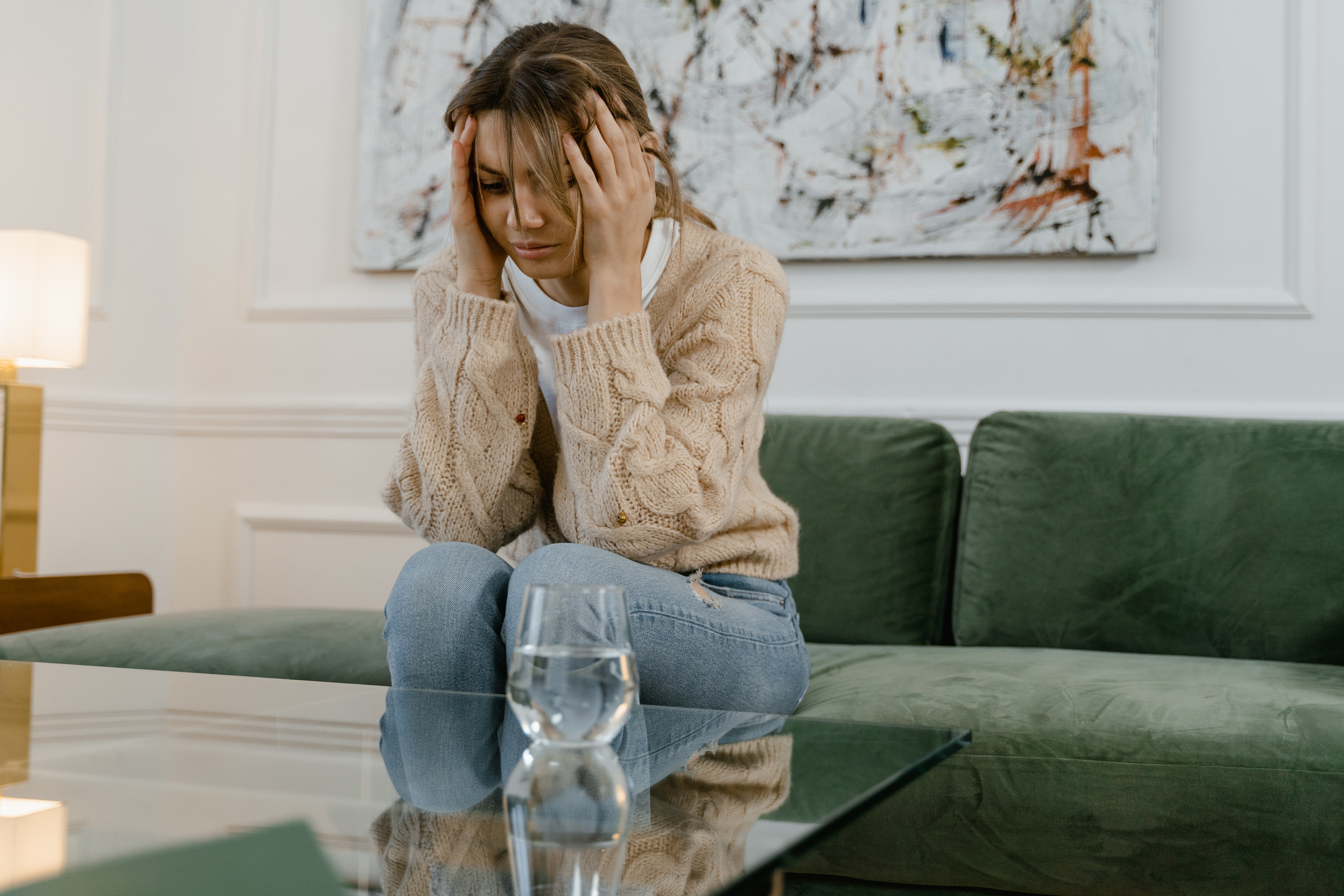 A Sad Woman Sitting on a Sofa